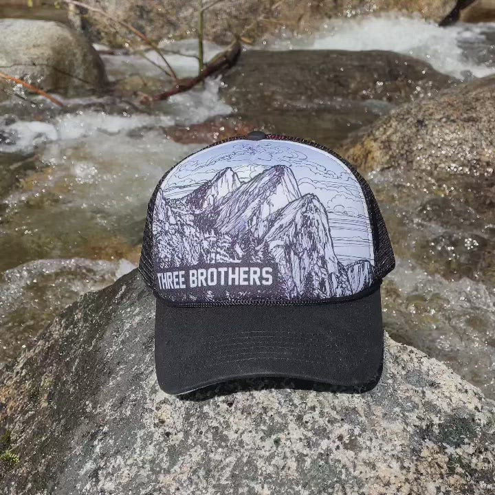 Video of a a Three Brothers trucker hat by a river  | Hiker Sight