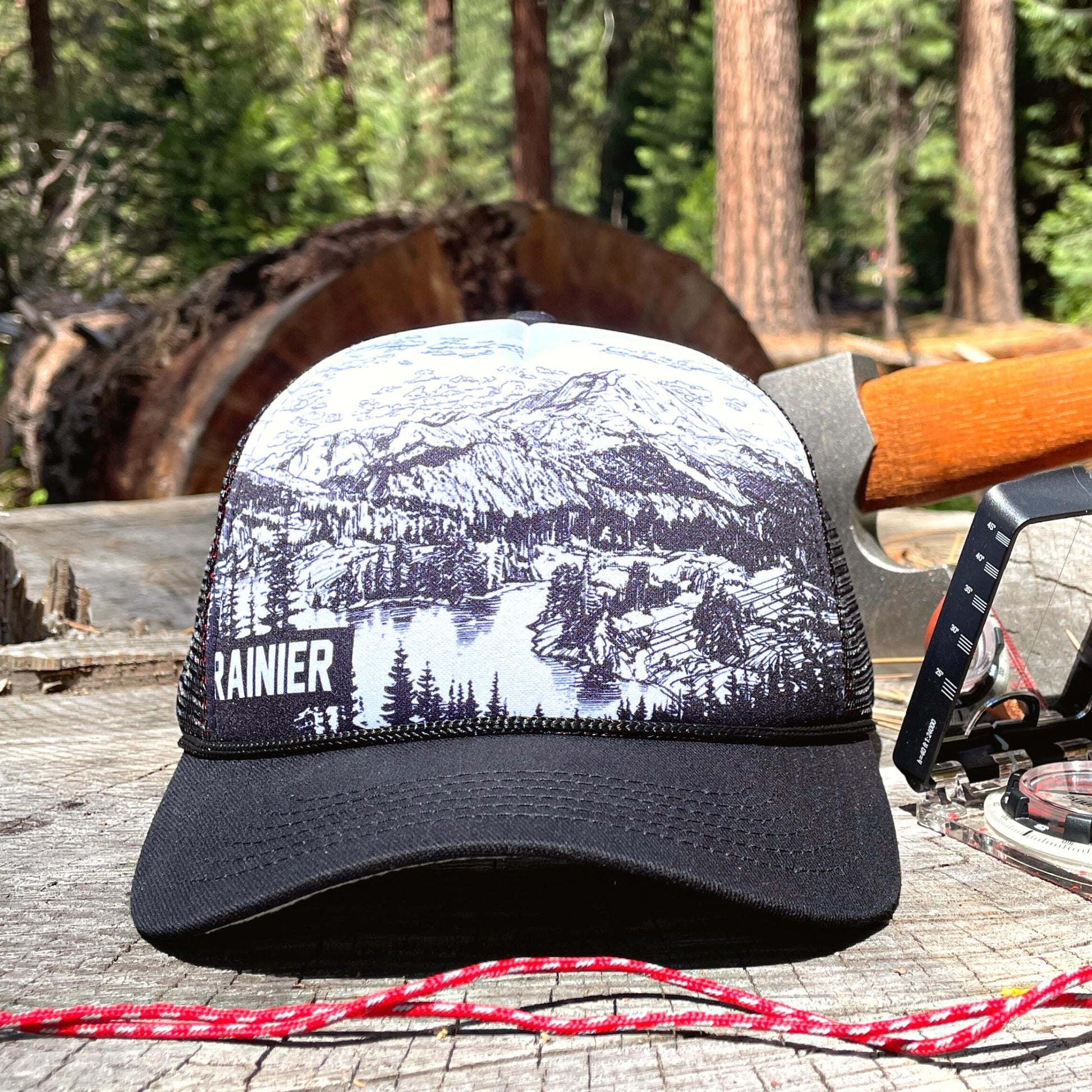 Mount Rainier trucker hat on a tree stump | Hiker Sight